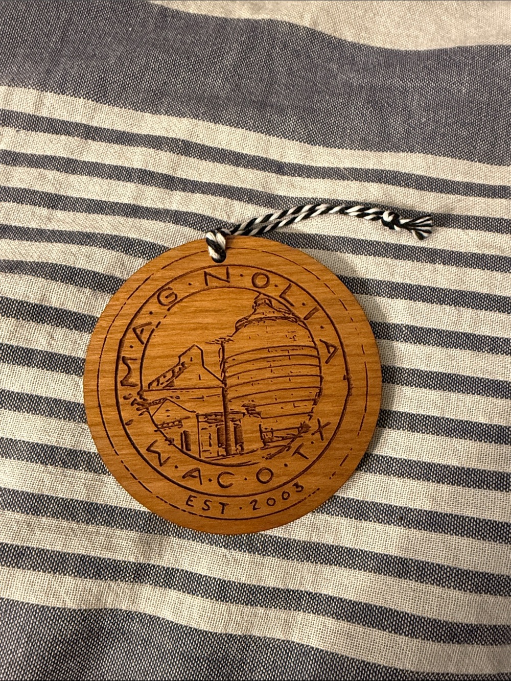 Magnolia Round Wooden Ornament in Natural Wood with Black Cord